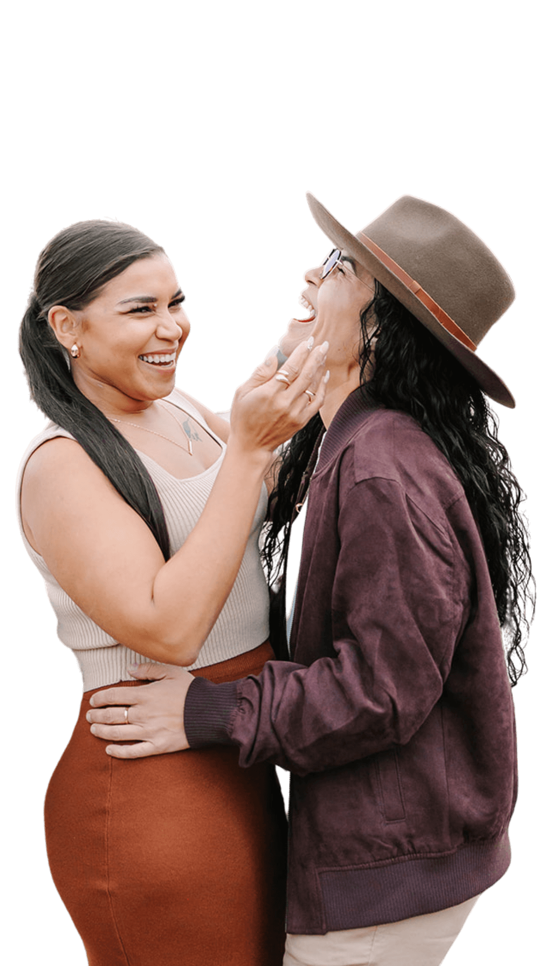 Lesbian couple at the Eiffel Tower after a proposal — one woman laughing as the other gently holds her cheek, captured at Bir-Hakeim Bridge during a romantic Paris photoshoot.