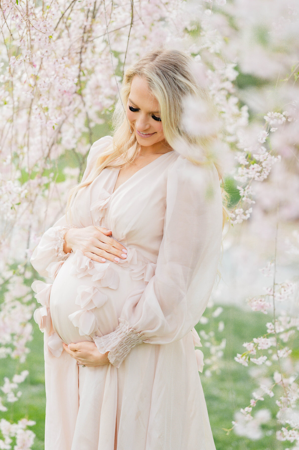 Pregnatn woman holding belly in Bristol, RI at Blithewold Mansion taken by best Maternity photographer in Rhode Island