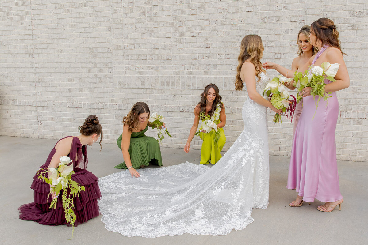 Bridal party fixing the bride's hair and dress before her ceremony, in Raleigh, NC. 