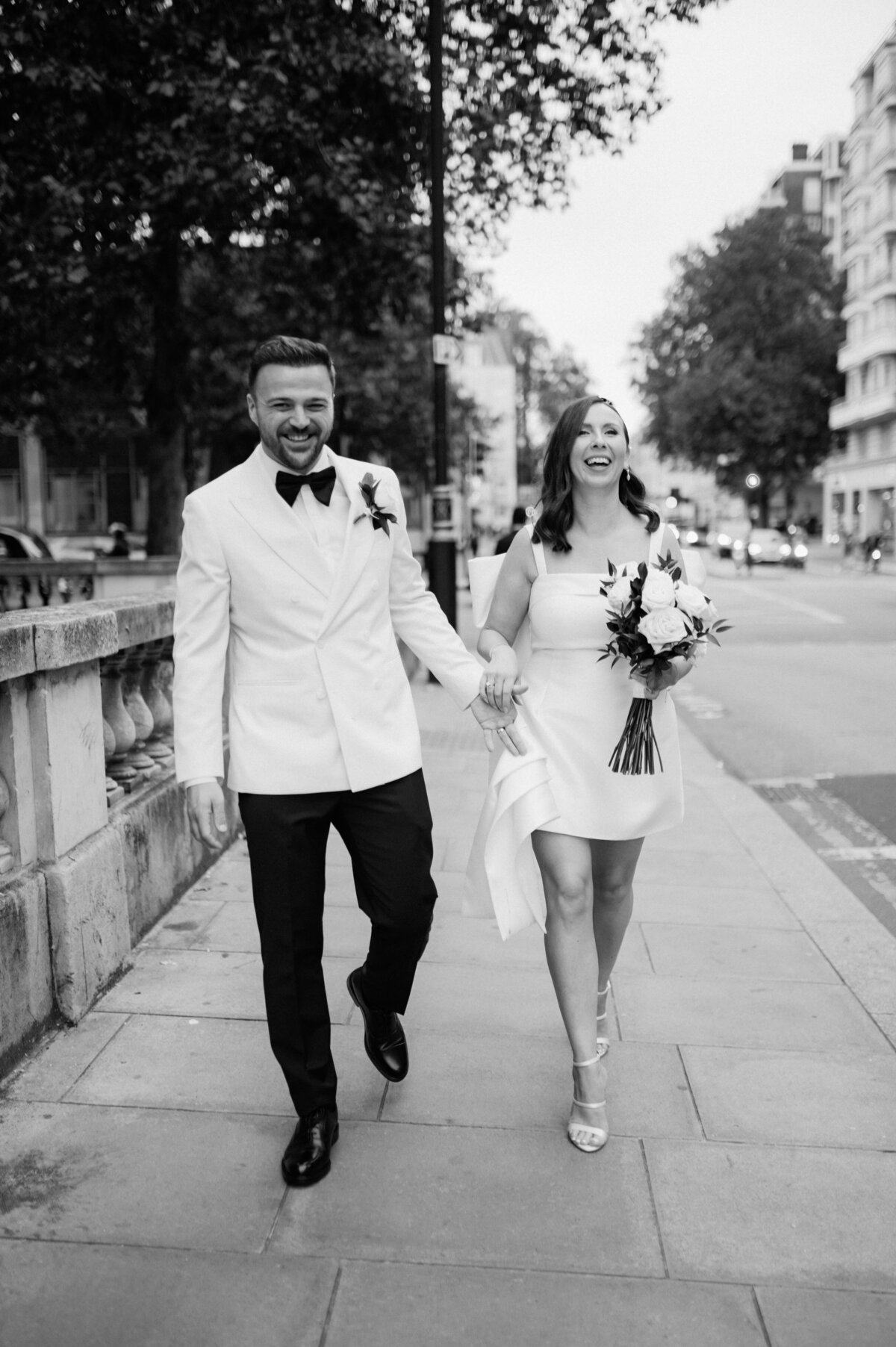 Candid city wedding in London – couple laughing post-ceremony