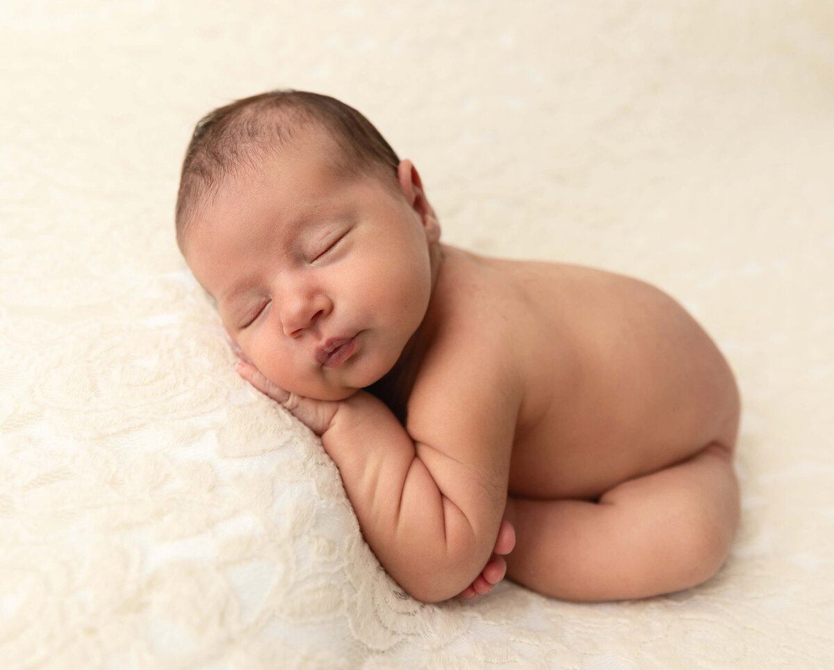 Newborn photo of a baby in a modified taco pose in an Erie PA photography studio