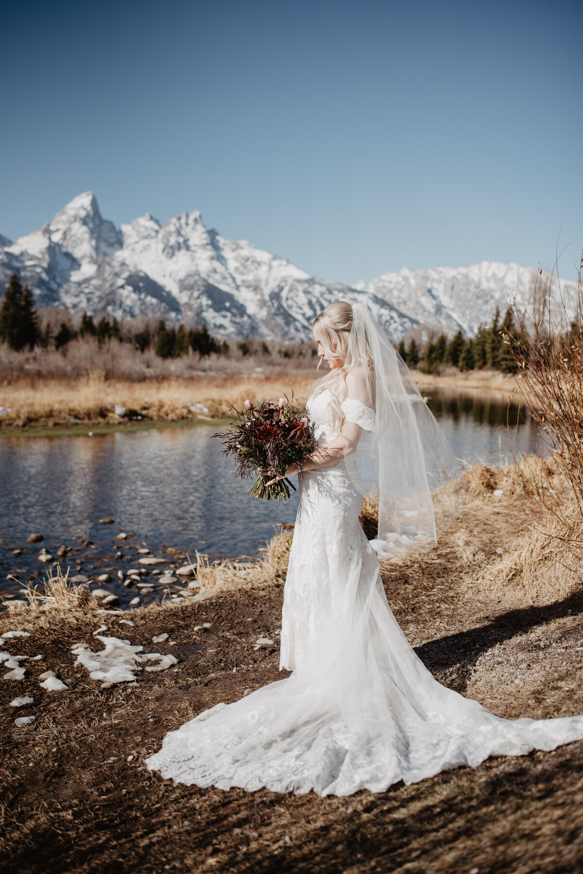 Jackson Hole Photographers capture bride wearing wedding dress holding bouquet