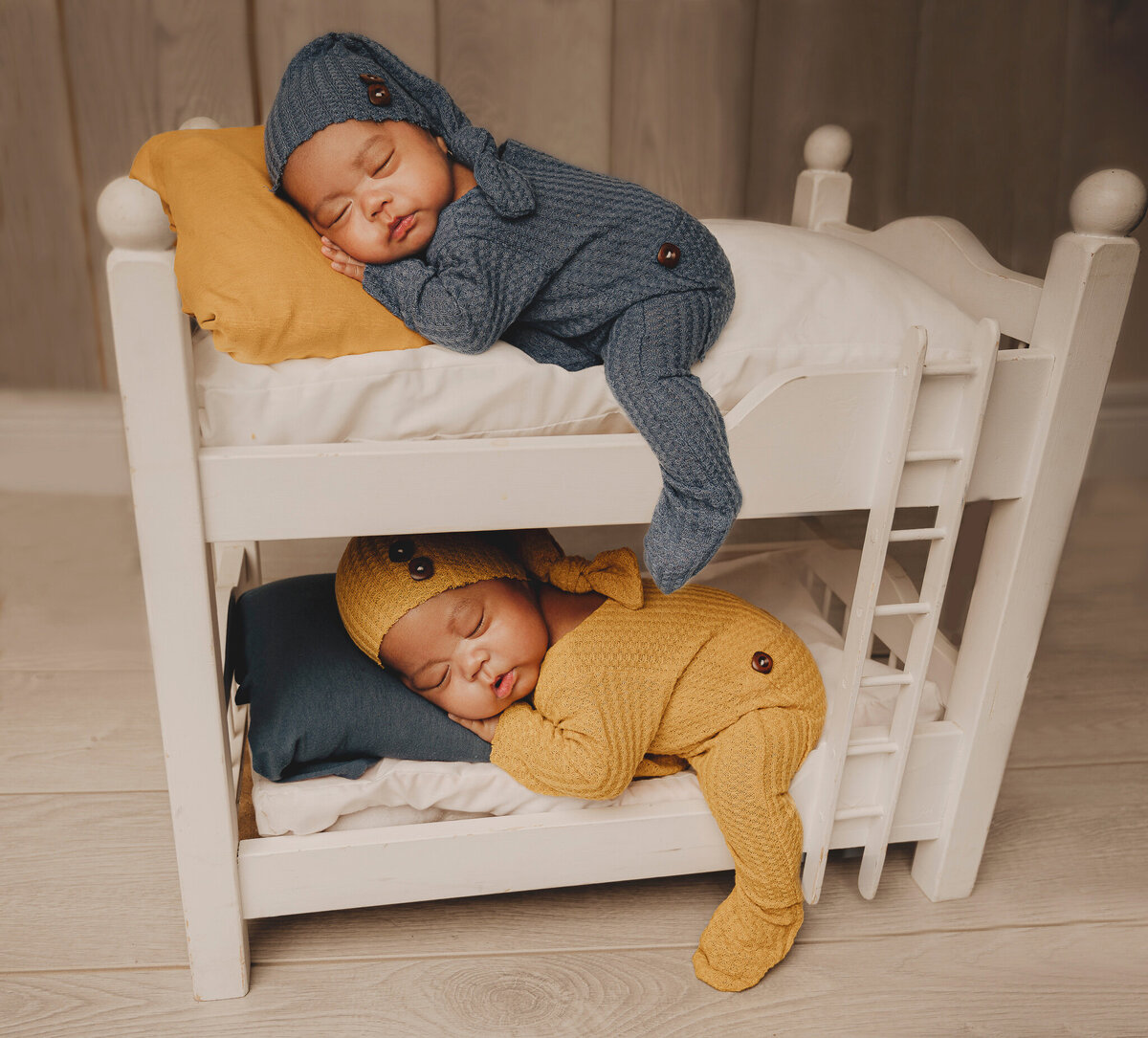 Newborn photography  Boy newborn twins sleeping on a white bunk bed wearing matching sleepers and hats near the Greater Toronto area.