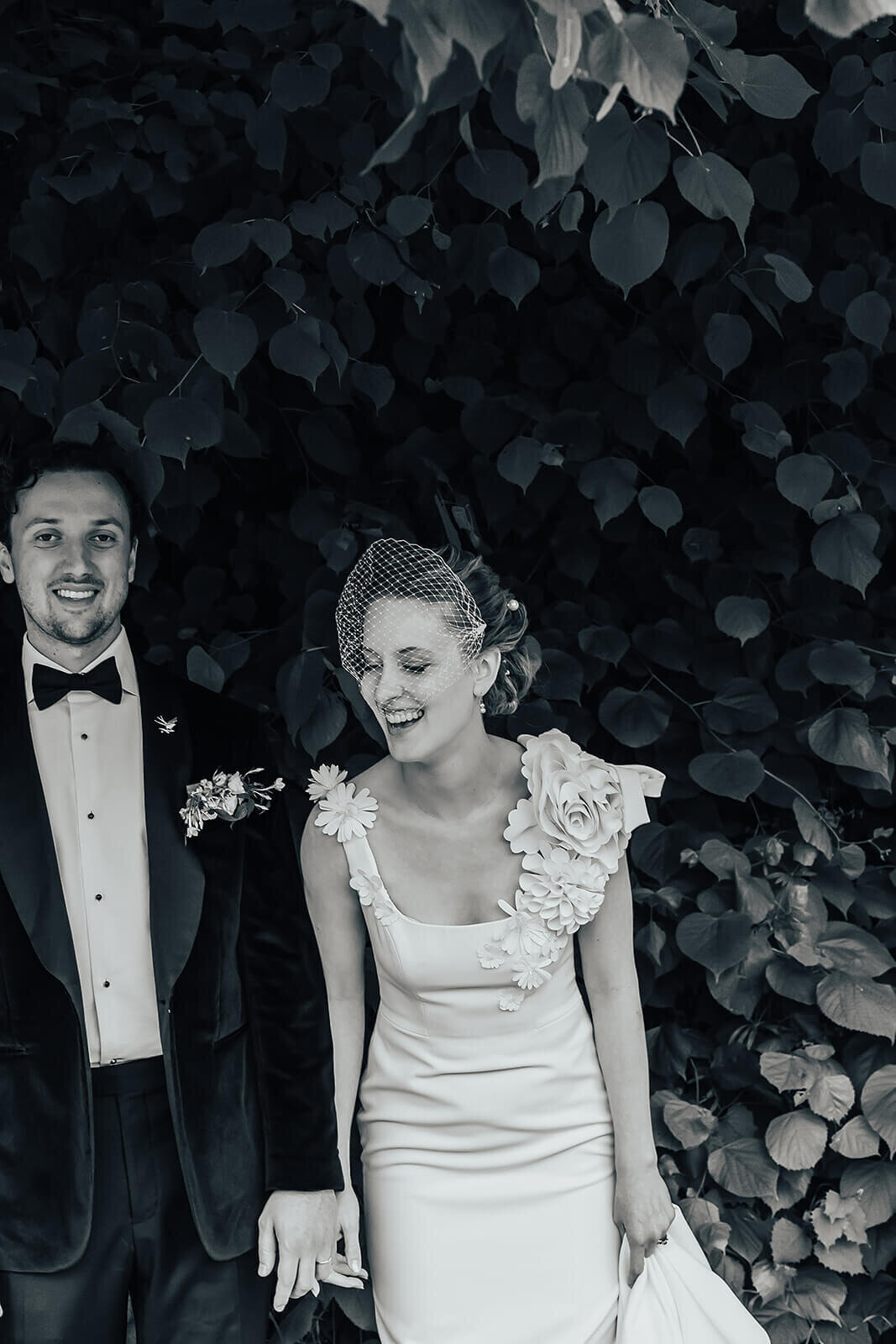 Bride and Groom laughing in black and white