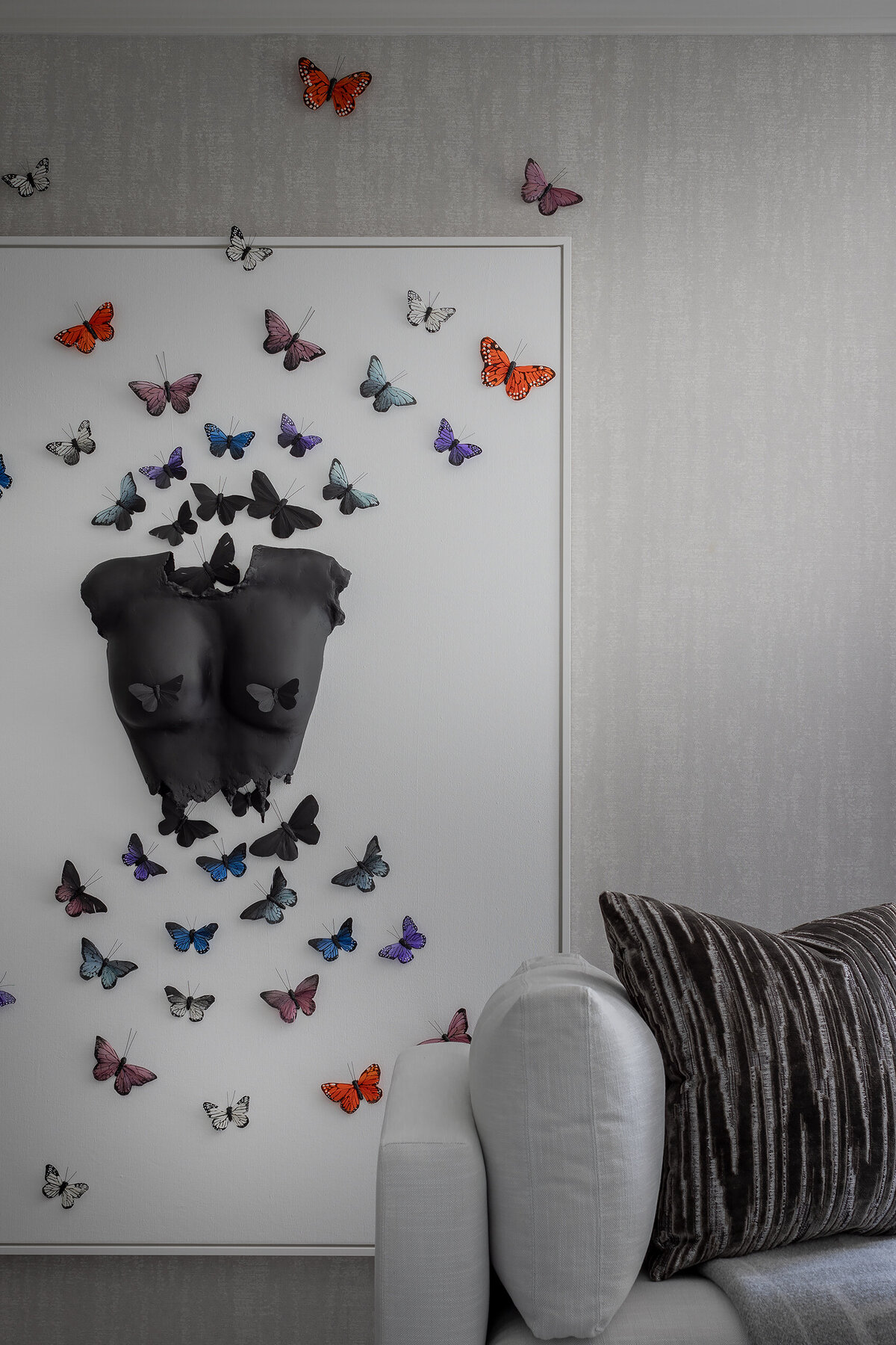 Modern Wellesley bedroom featuring a butterfly art installation above the bed and soft neutral styling