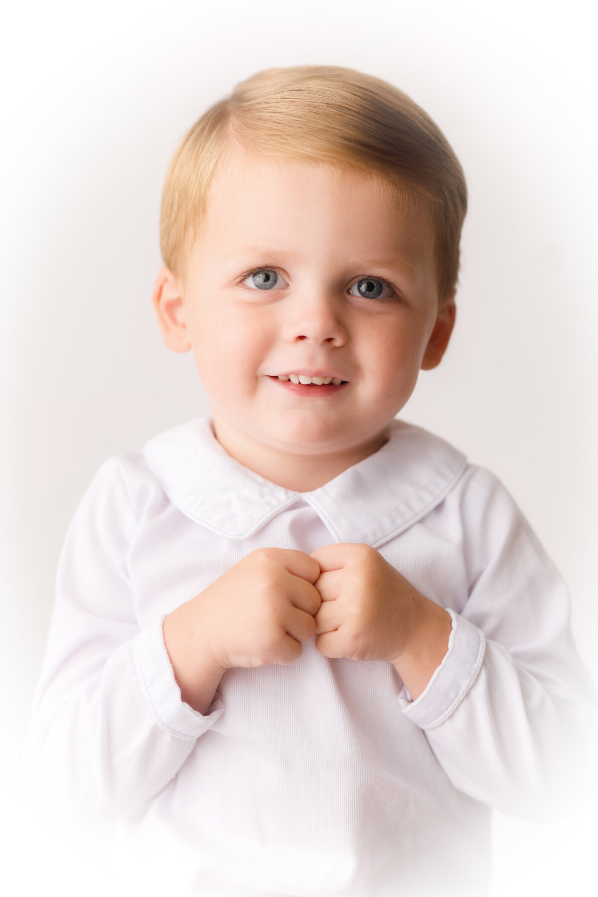 Little boy smiles at the camera during Heirloom Portrait Session in Charleston, SC.