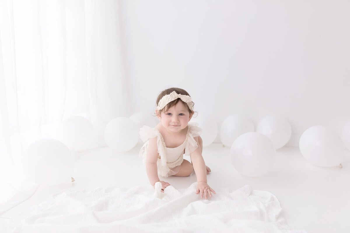 white setting for a first birthday photo session in Medina Ohio studio