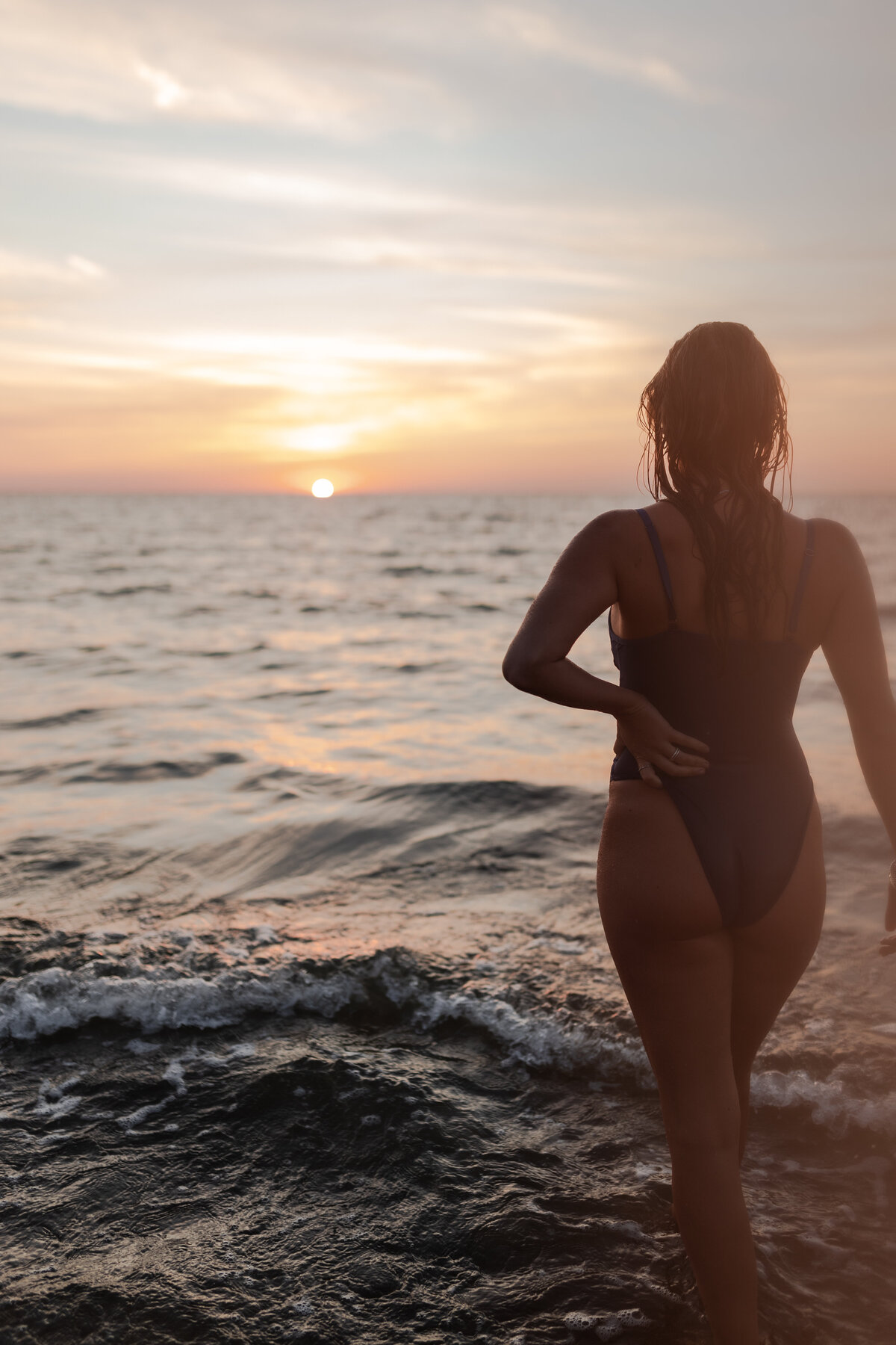 Gentle play of light and shadow on a woman's body during golden hour.