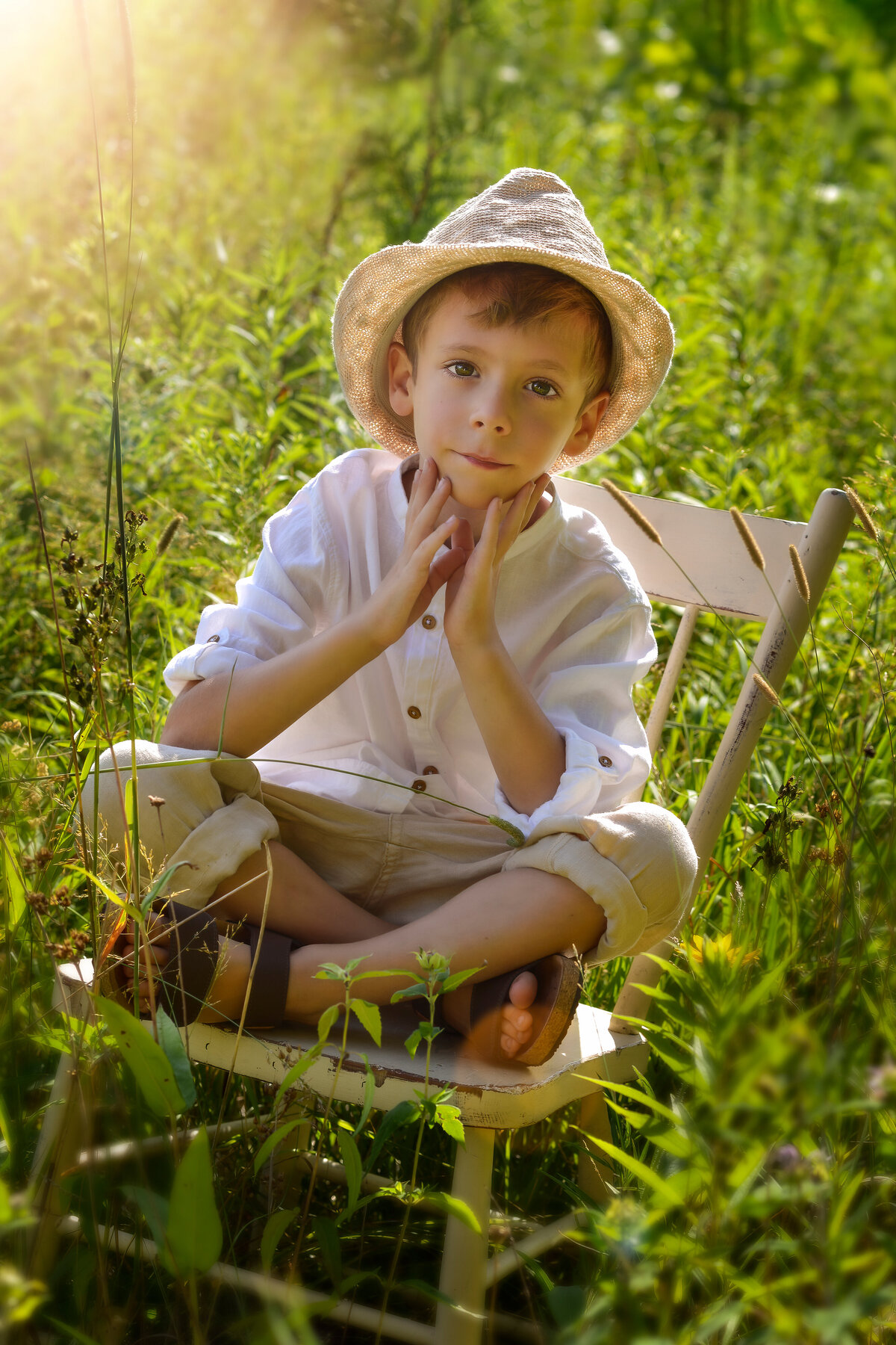 Milestone portrait of a boy in nature during golden hour—vintage vibes with peaceful summer tones.