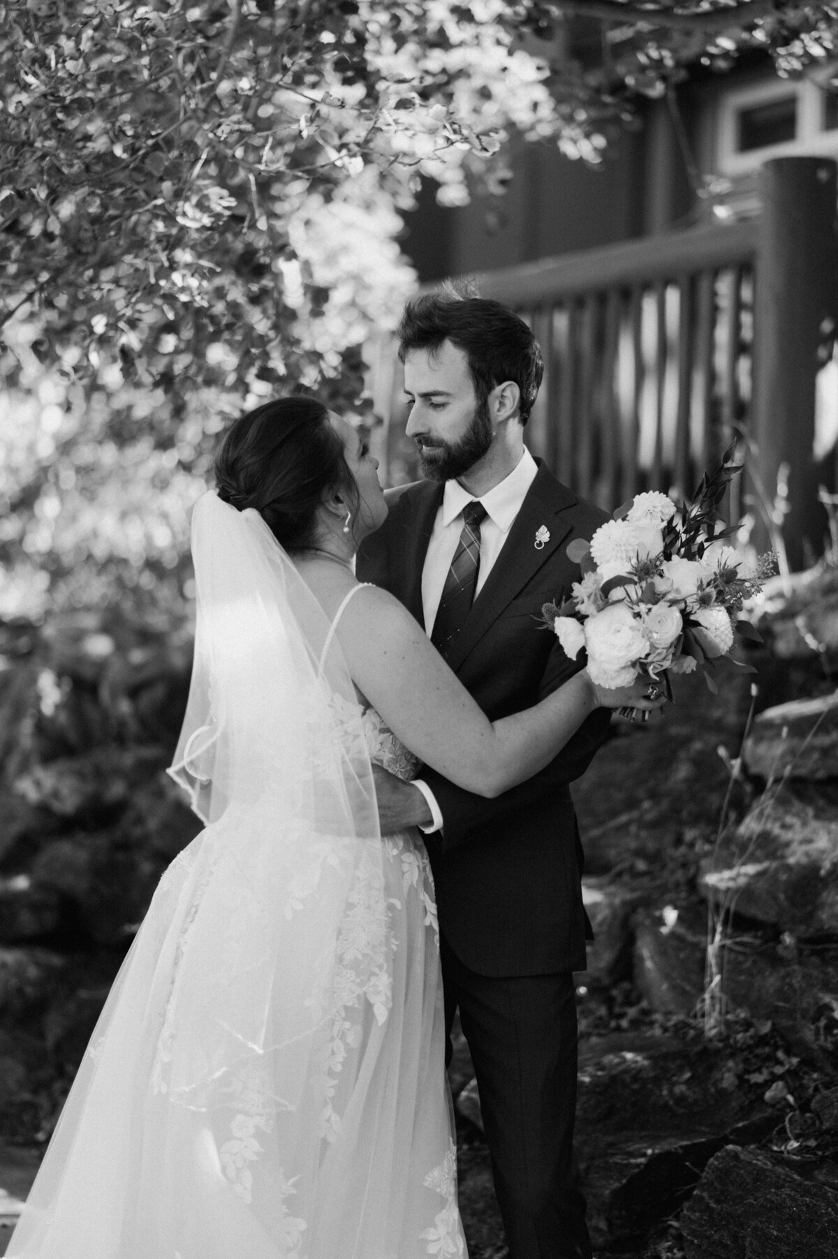 Black and white photo of Meghan and Greg facing each other on their wedding day