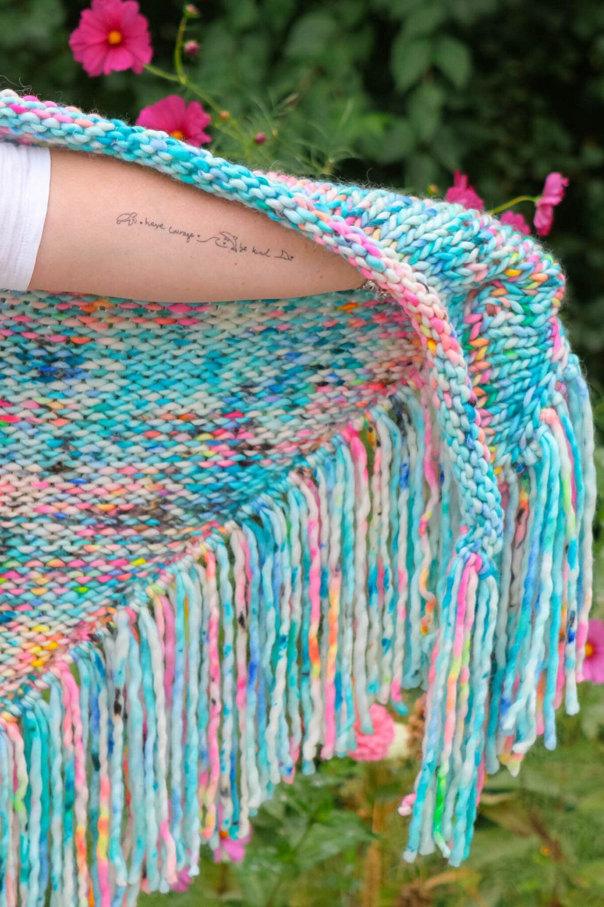 hand knit shawl with fringe and tattoo