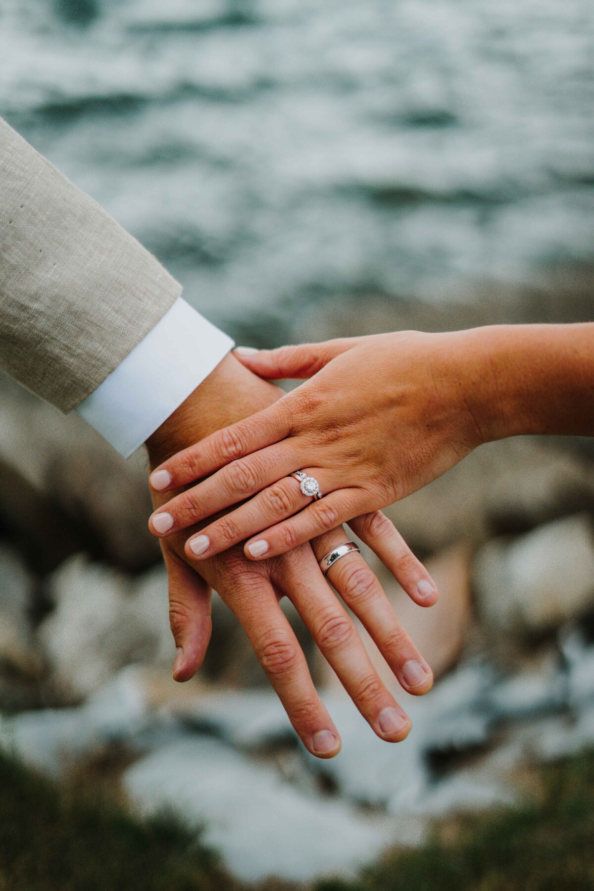 a couple with their hands together showing their rings
