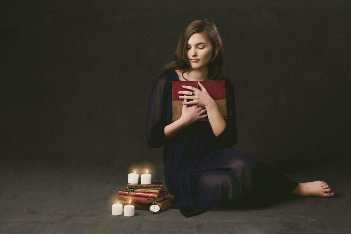 Senior Picture Photographer Captures Thoughtful Portrait With Books And Candles-30