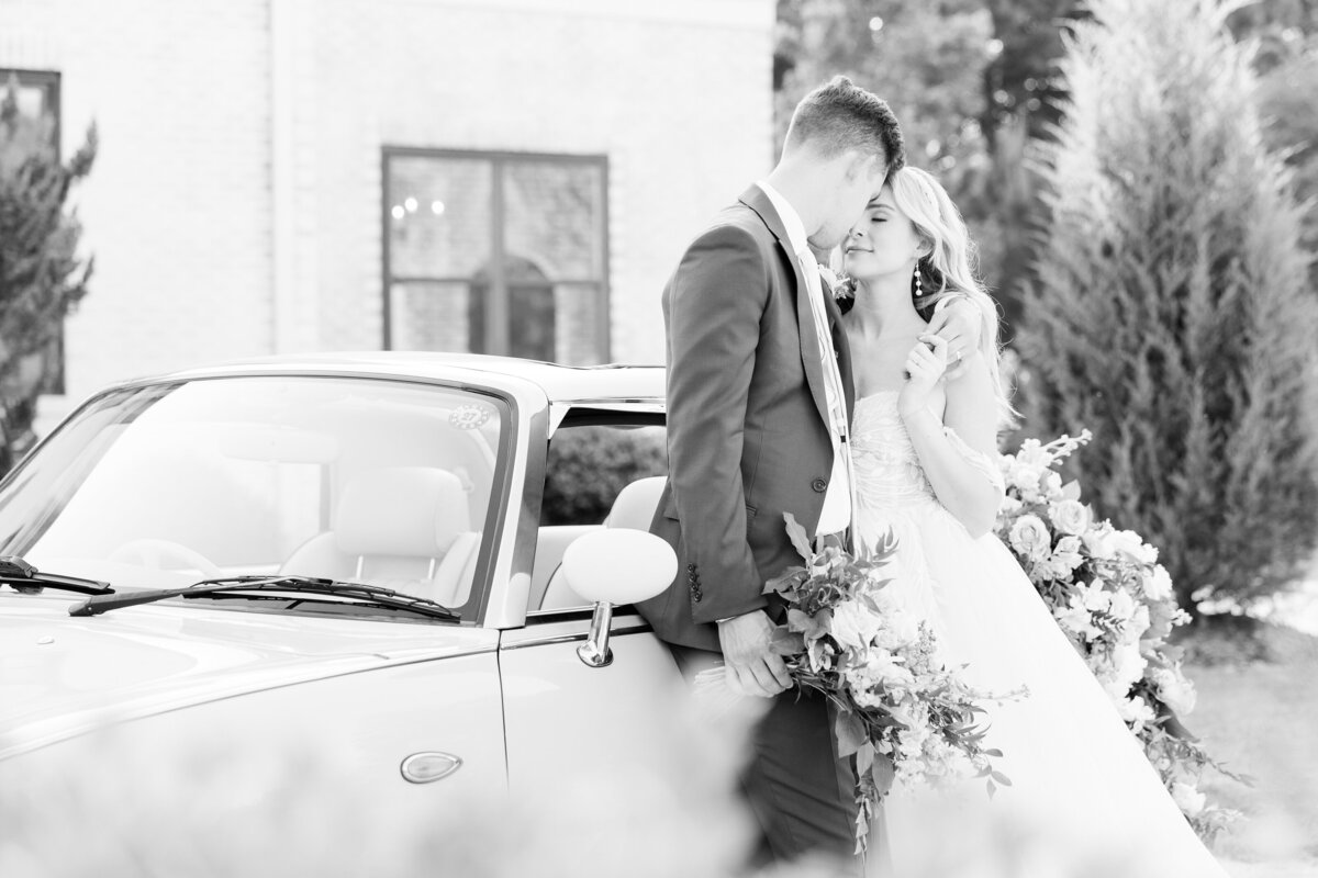 Classic car wedding getaway car black and white bride and groom emotional moment