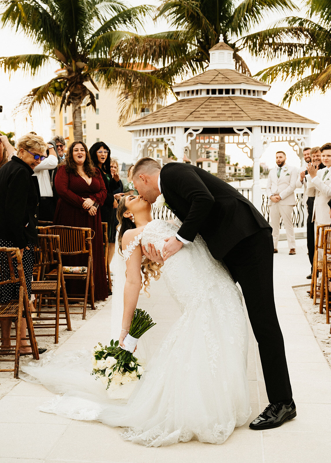 Bride and groom kiss right after ceremony conclusion  at St Pete yacht club