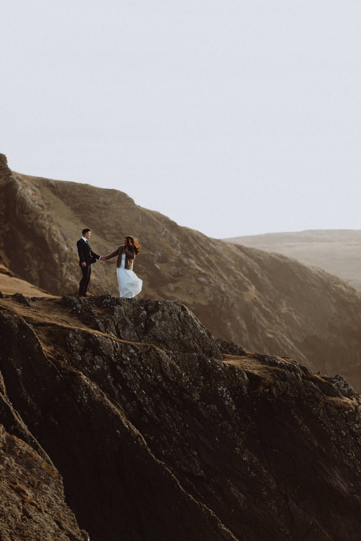 bride and groom on cliff edge