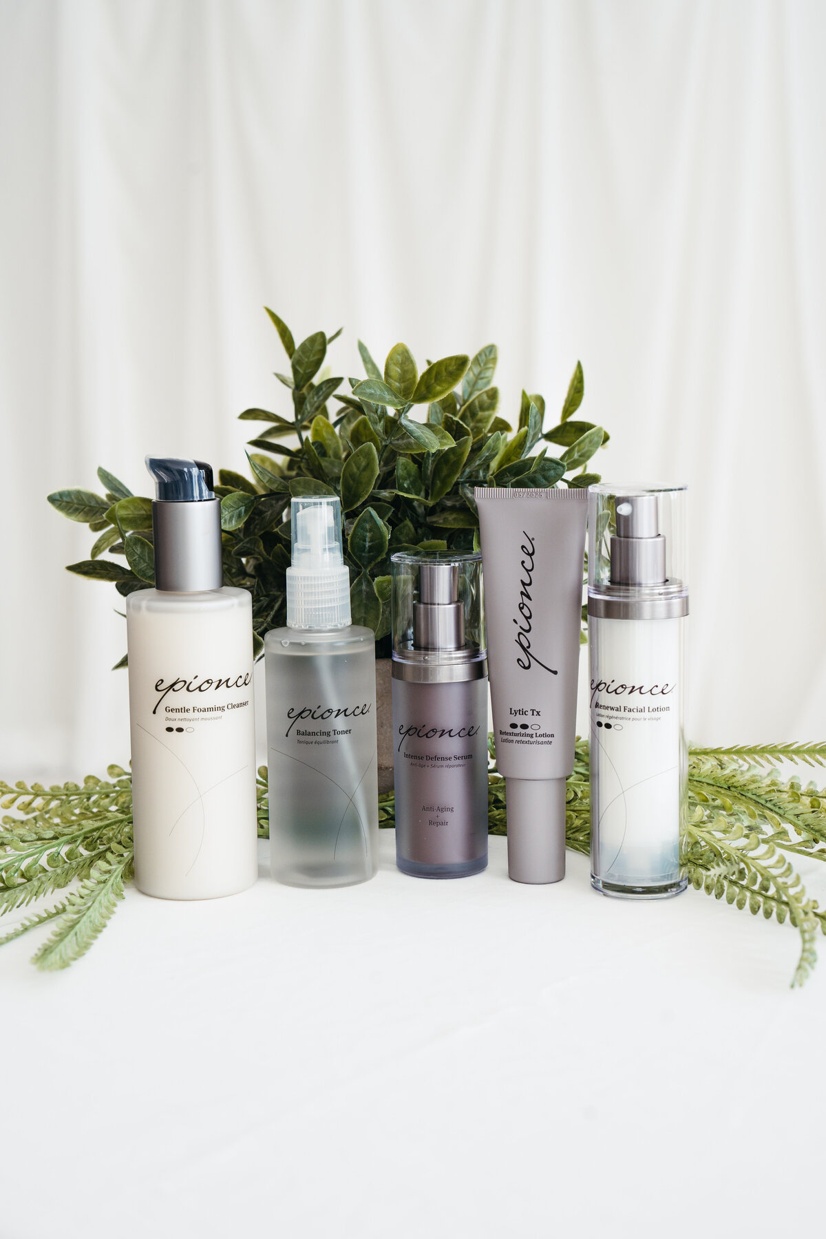 Expanded display of Epionce products including masks, creams, and serums arranged with ferns at Maxwell Aesthetics Salem
