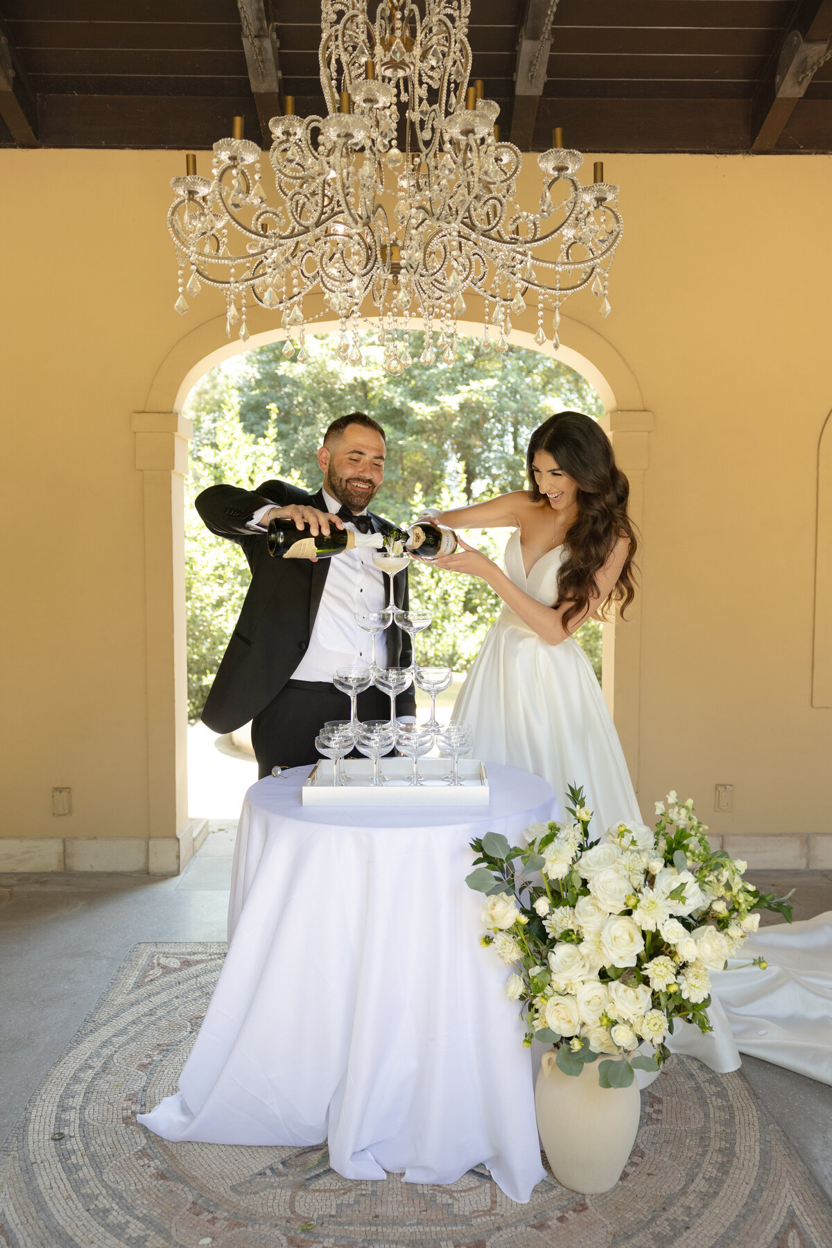 Bride and Groom pouring champagne into champagne glasses