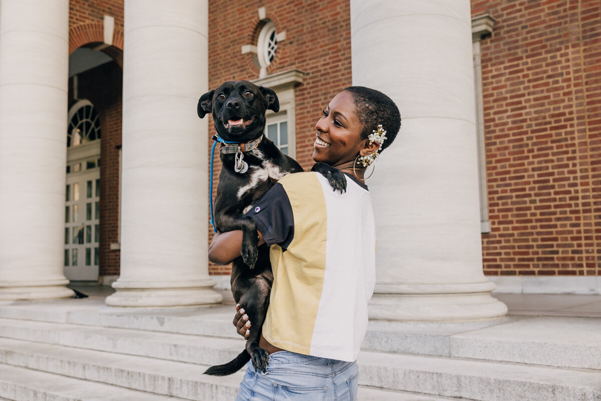 Vanderbilt University senior holding her black dog during graduation portrait session