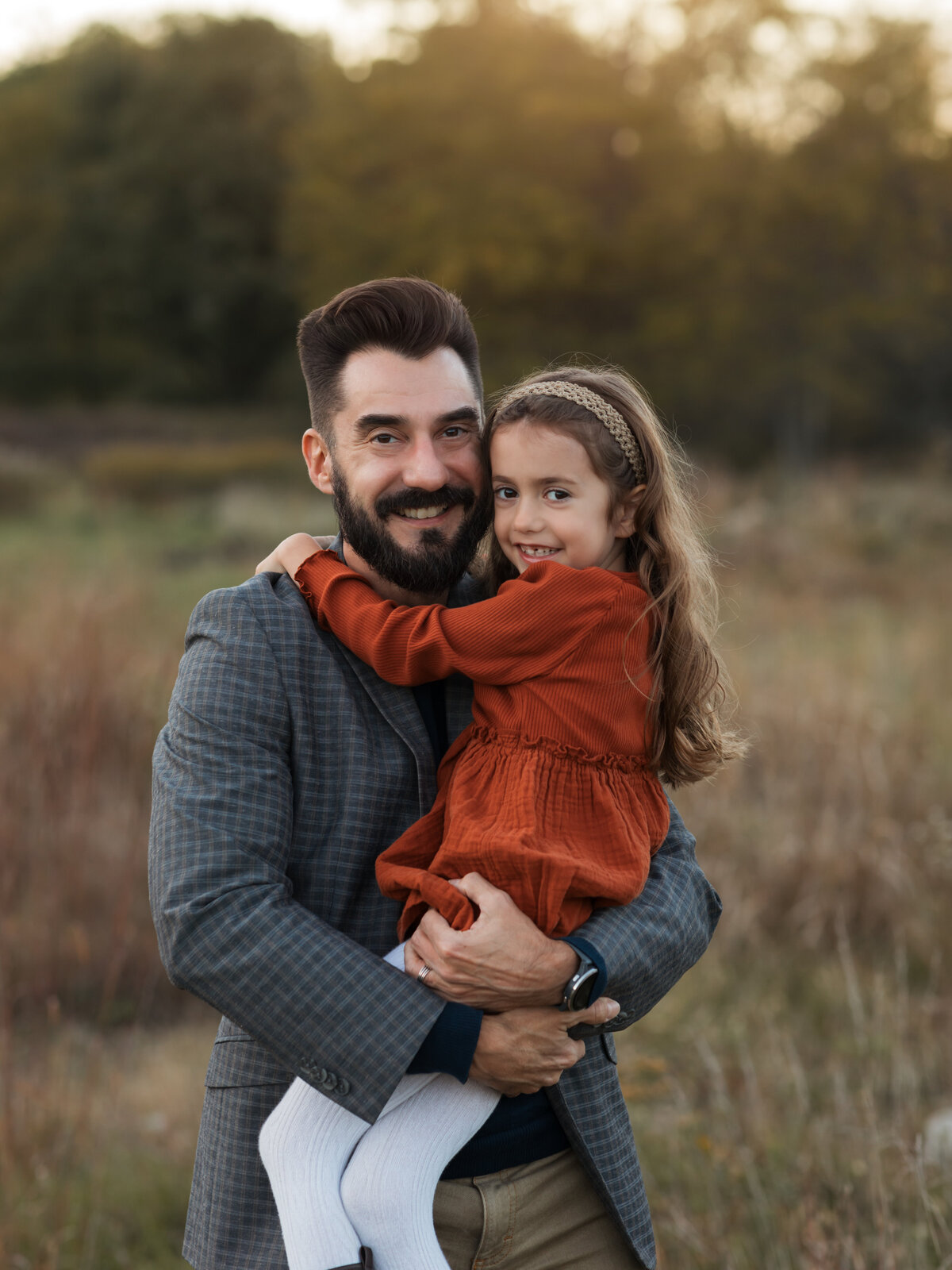 dad hugging daughter for family photos in field cleveland family photography