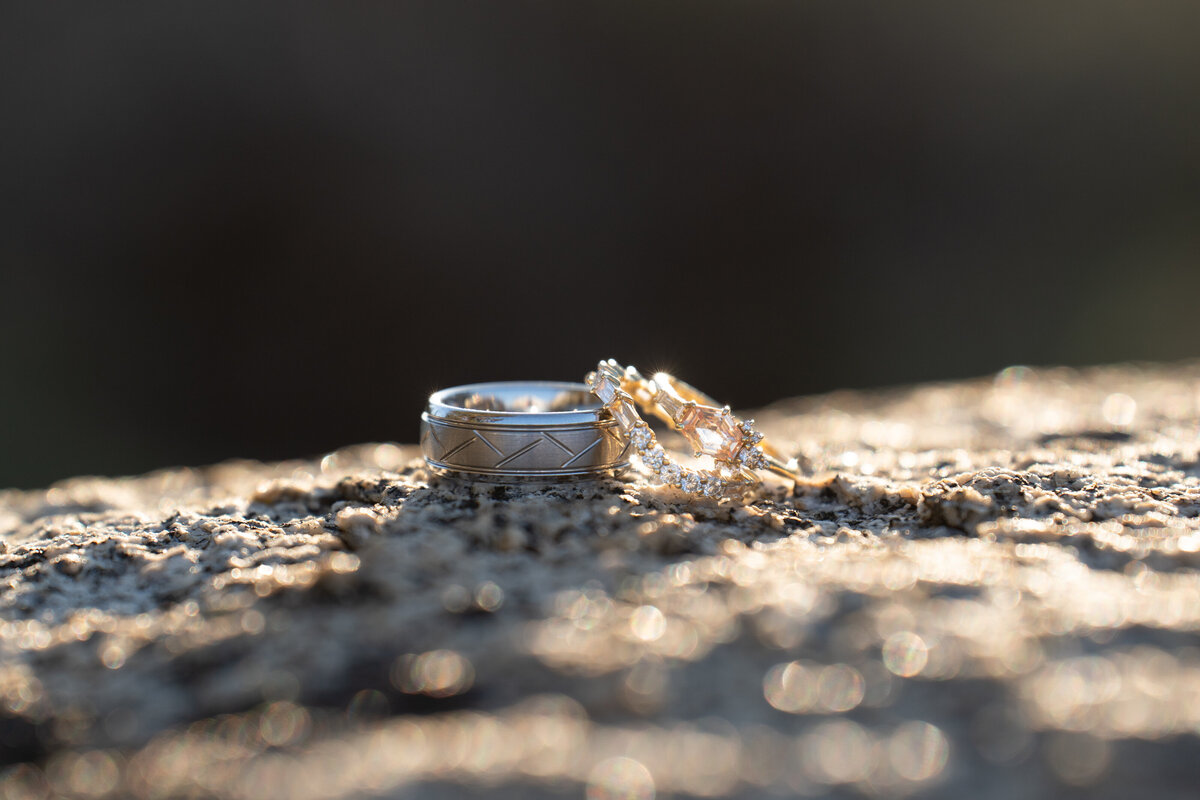 Two wedding rings sitting on a rock