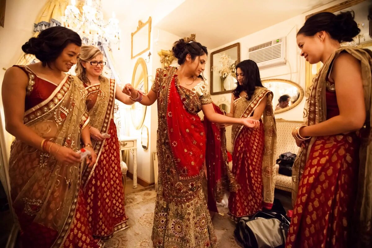 A vibrant scene of women in traditional South Asian wedding attire