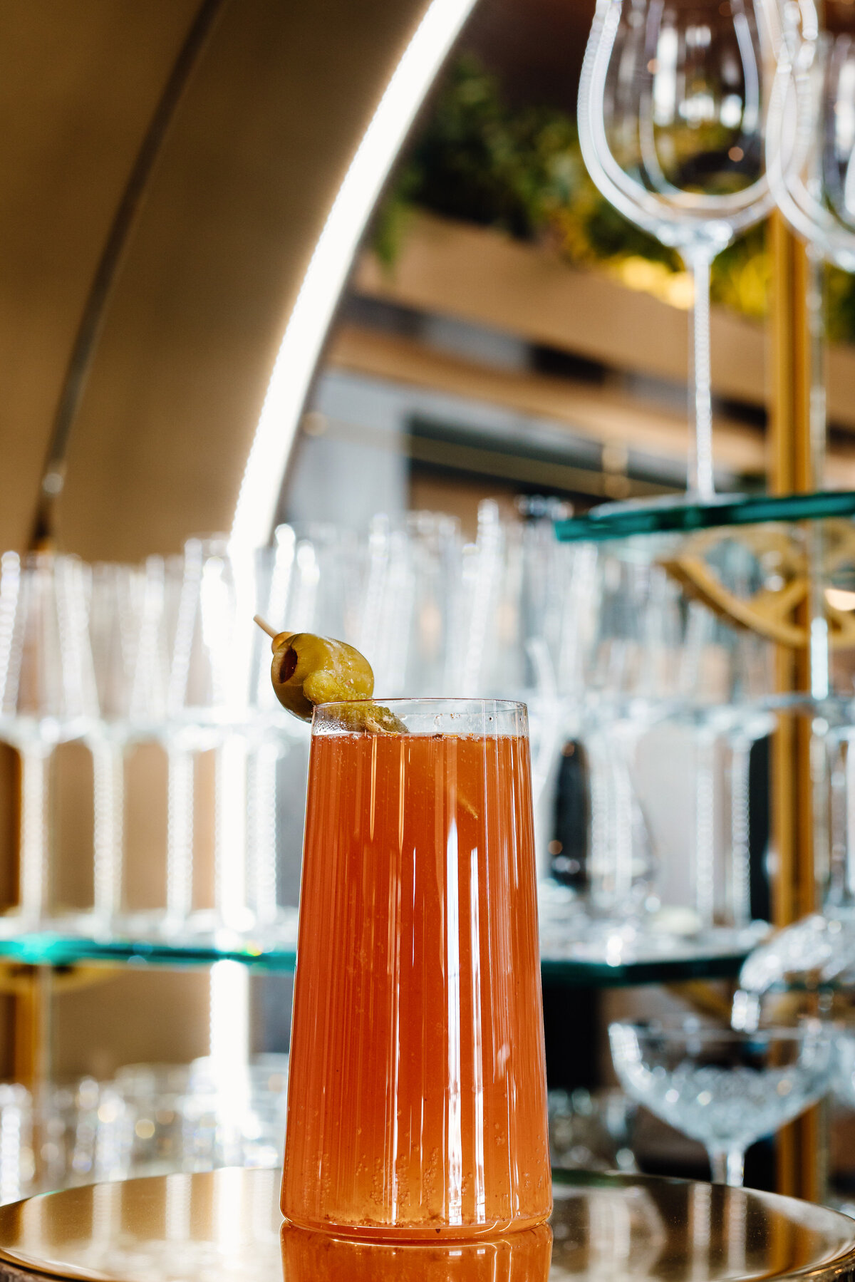 A cocktail sitting on a silver platter