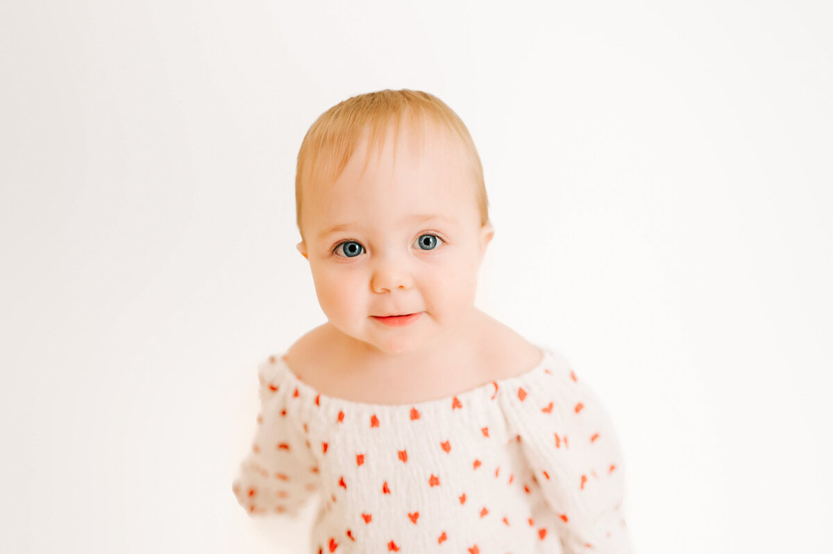 close up of baby girl face  in white photography studio in Springfield MO