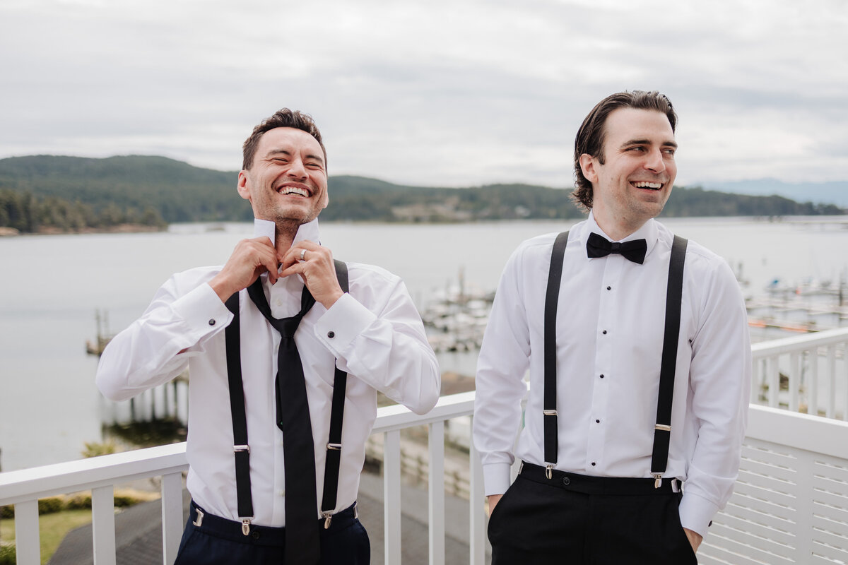 Groomsmen helping groom prepare on wedding day