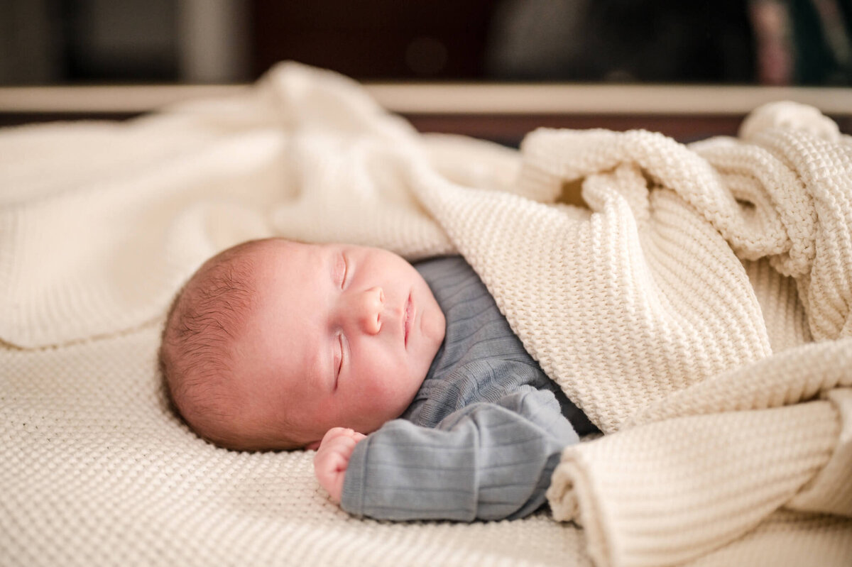 Baby sleeping under blanket