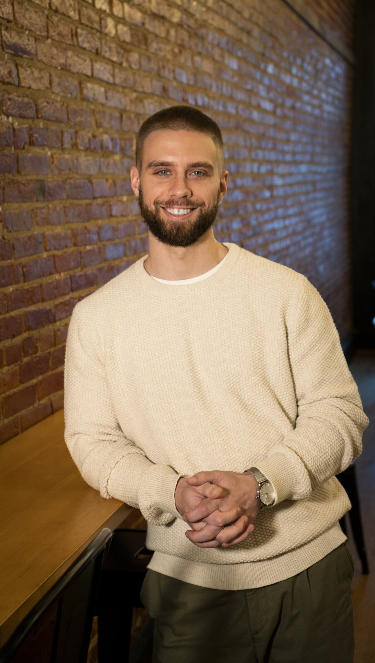 Headshot of a young man in a coffee shop