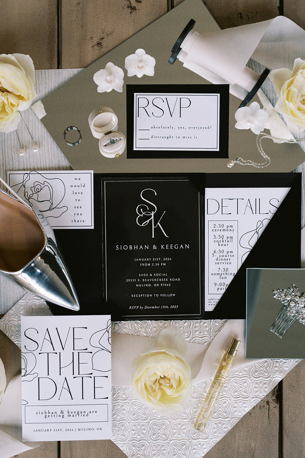 A wedding flat lay featuring invitations, shoes, flower and hair comb among other items.