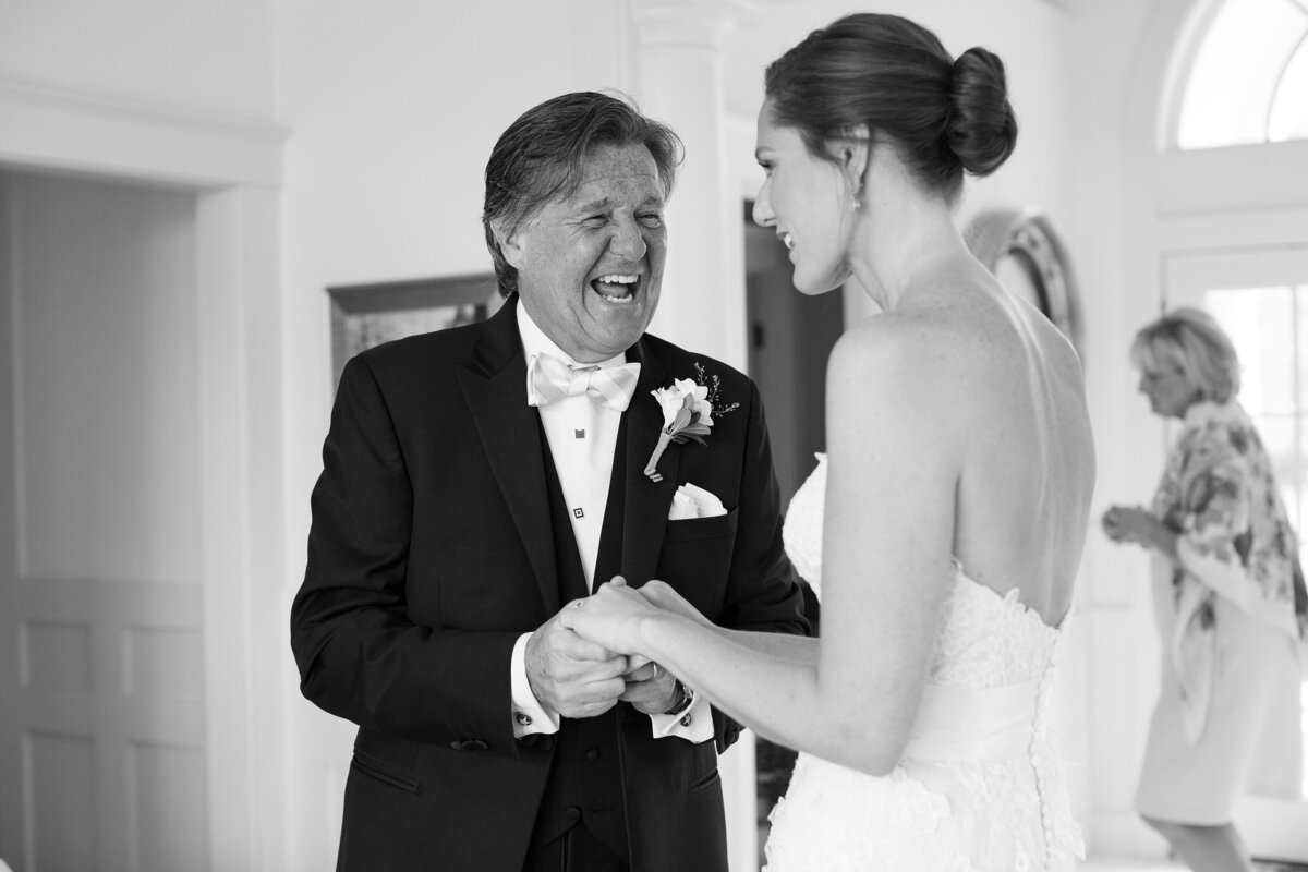 Father smiles toward Bride after seeing her on wedding day.