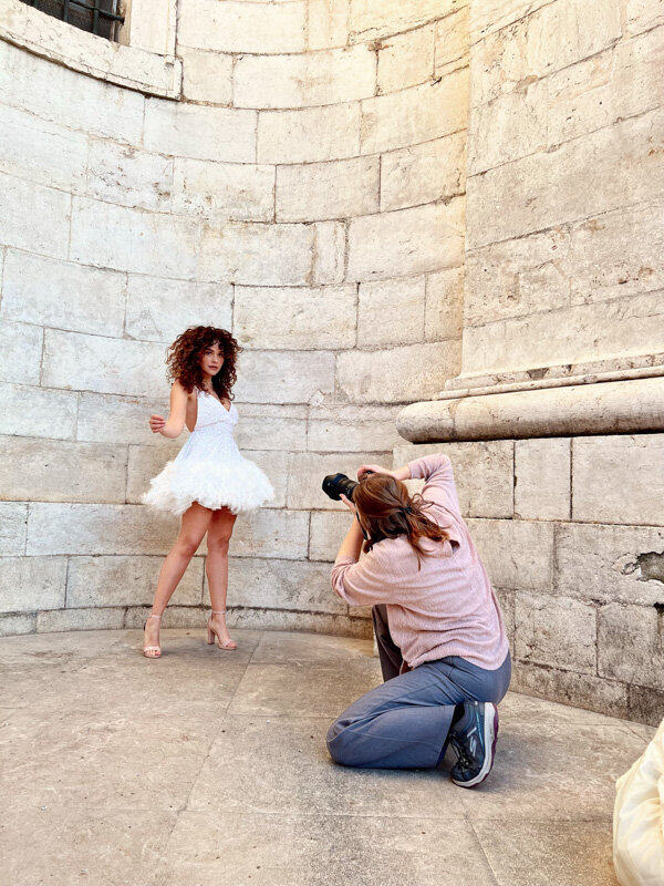 Female photographer working with a model in the city of Lisbon
