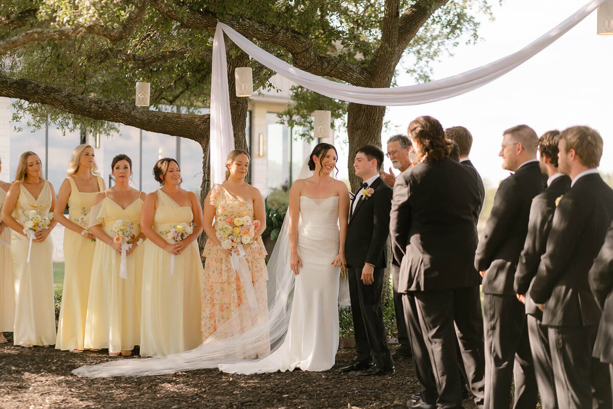 during their ceremony, the couple looks out at their guests