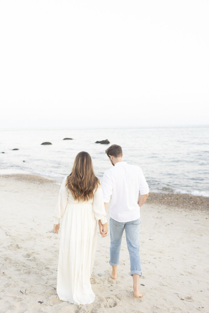 Walking on the beach at Harkness Park during engagement photoshoot