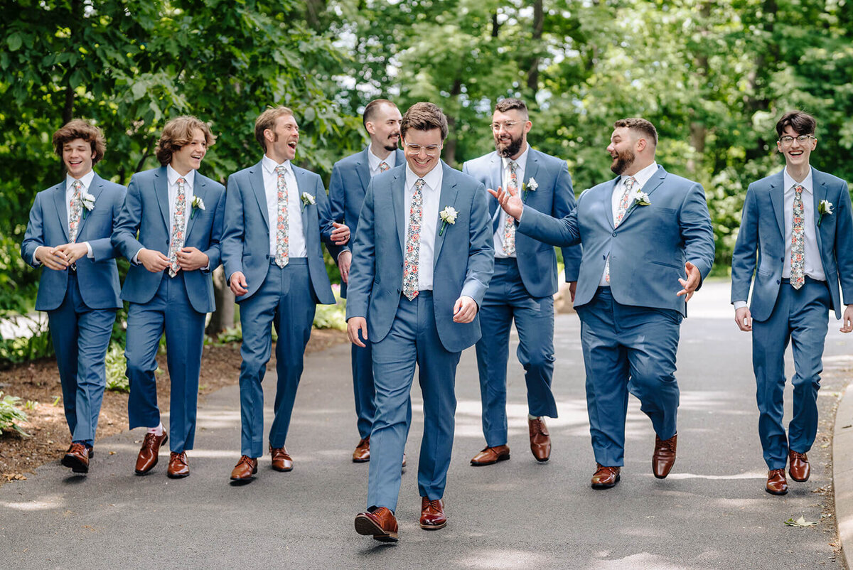 Groom with groomsmen wearing blue suits at Oswego wedding, NY