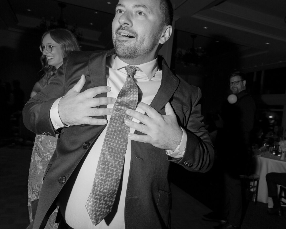 wedding-guest-dancing-holding-chest