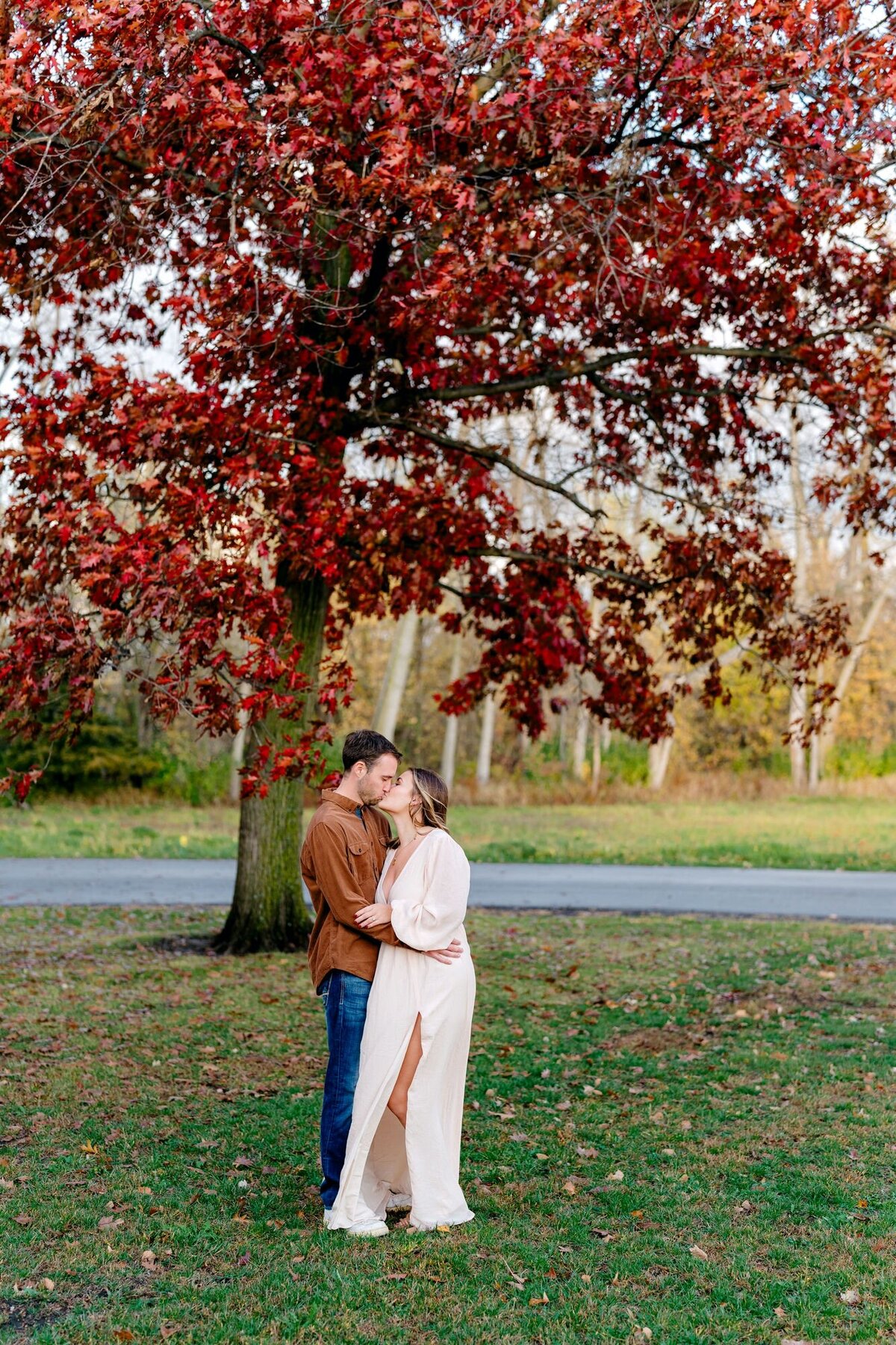 kissing-red-fall-tree-couple-session