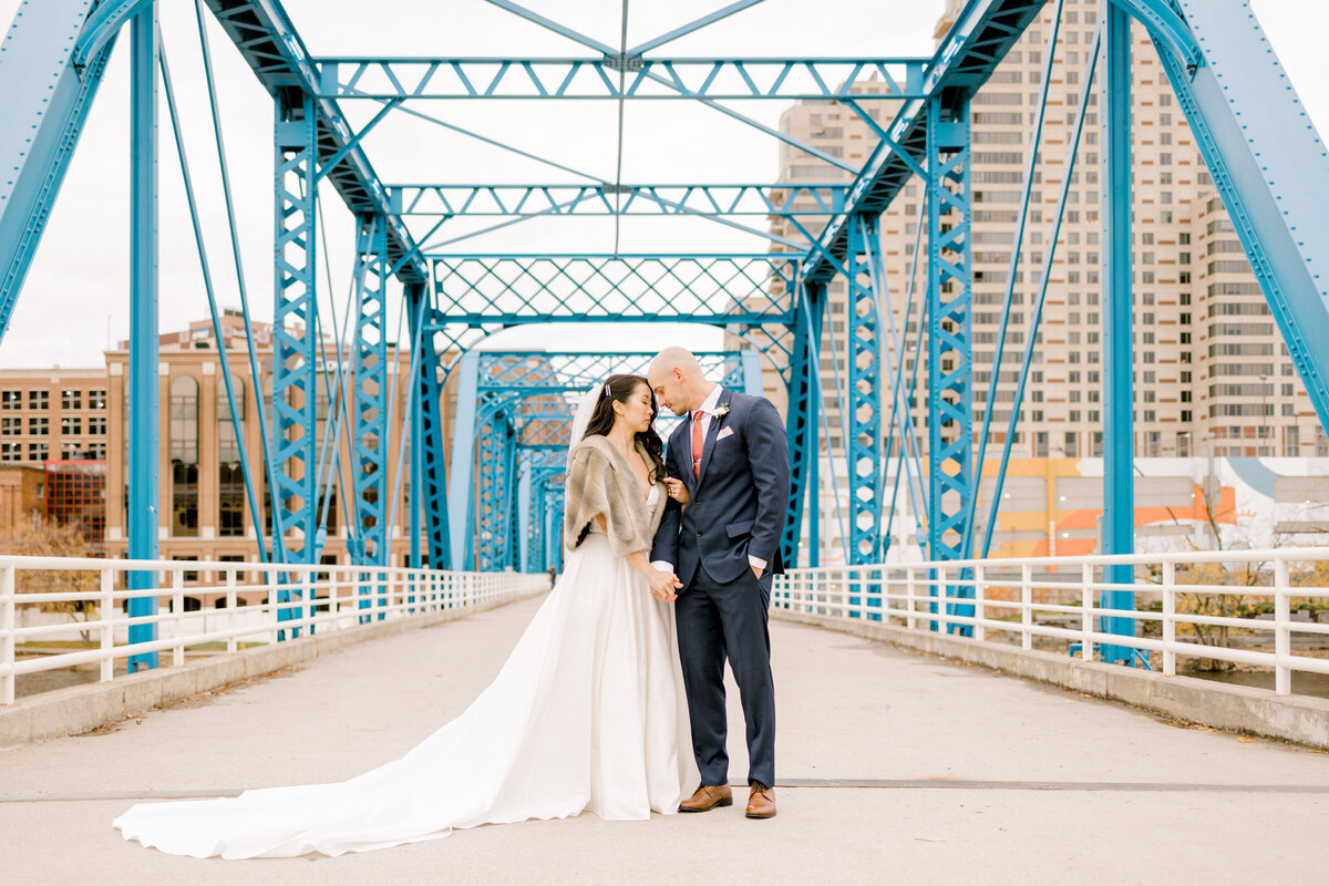 couple standing on blue bridge