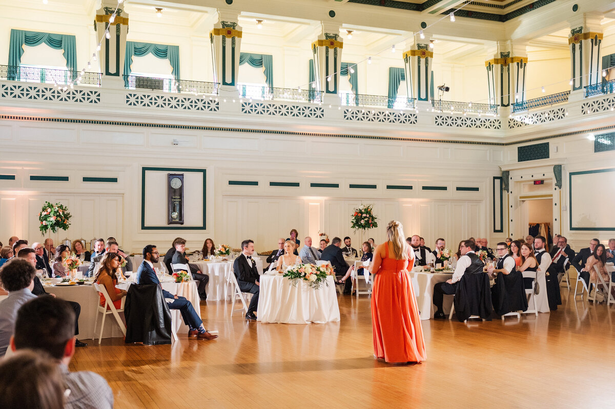 sister giving a wedding speech at a wedding inside of soldiers and sailors memorial hall