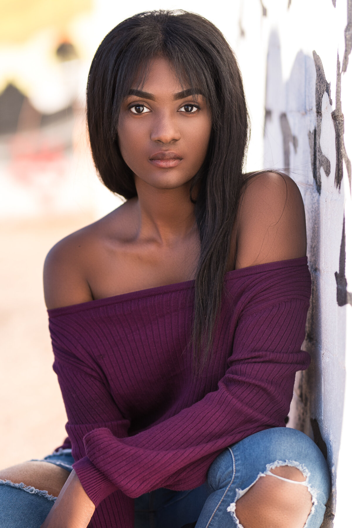 photo of high school senior girl with long black hair and purple top