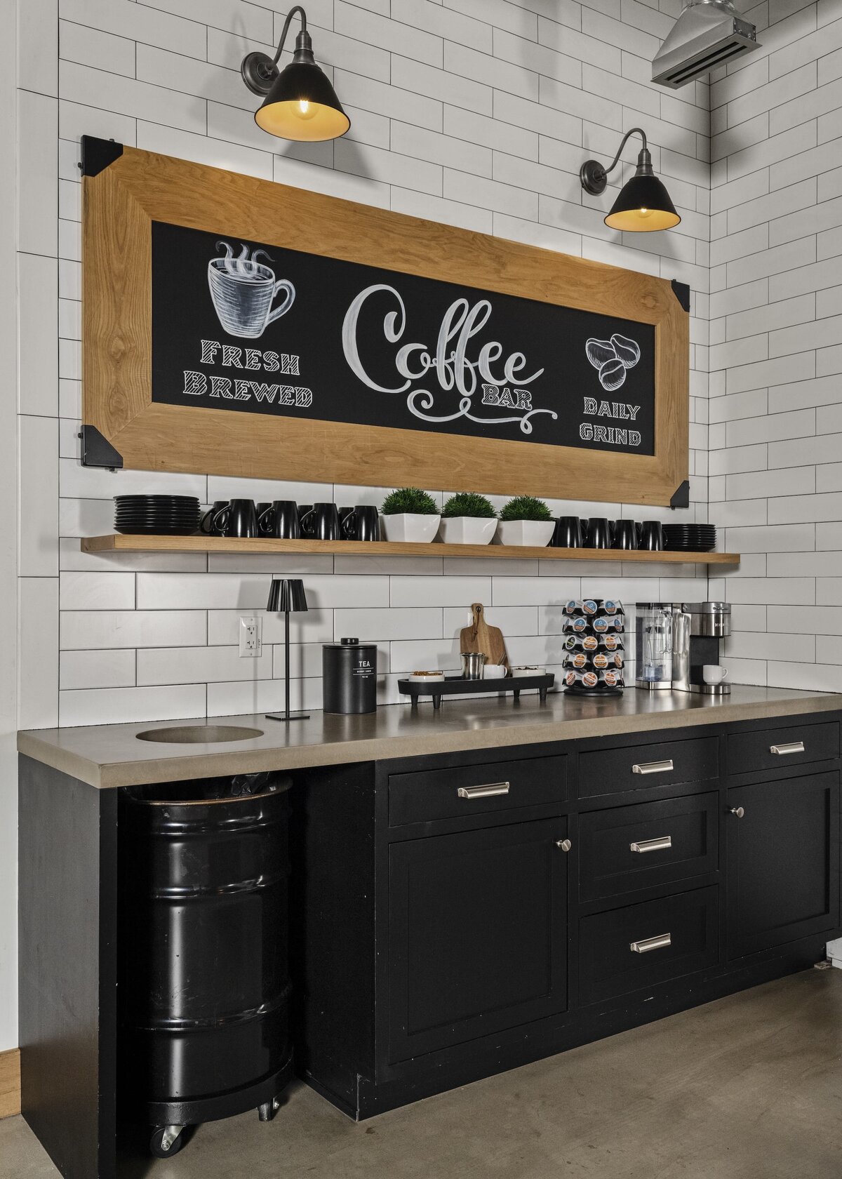 candra lynn interiors old bridge project coffee bar area in kitchen with large wood sign and black cabinets