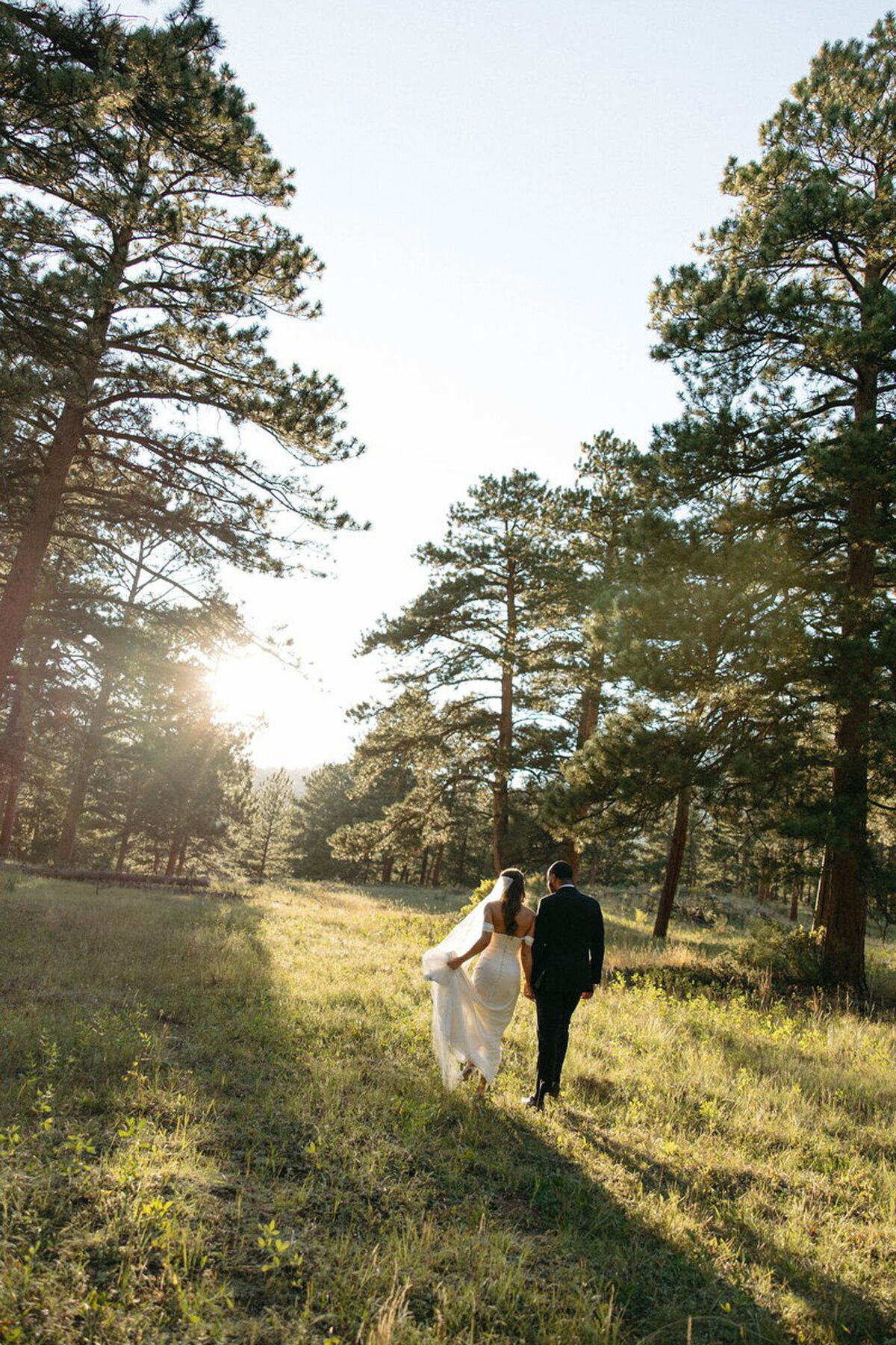 Bride and groom walking through field, by Marissa Nicole, one of the best photographers in orlando fl