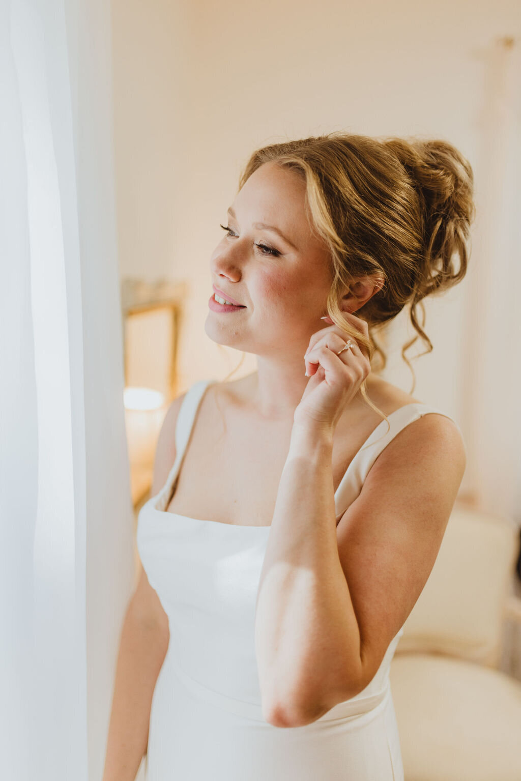 Bride with elegant updo and bridal glam makeup in Chicago, IL. Wedding beauty services.