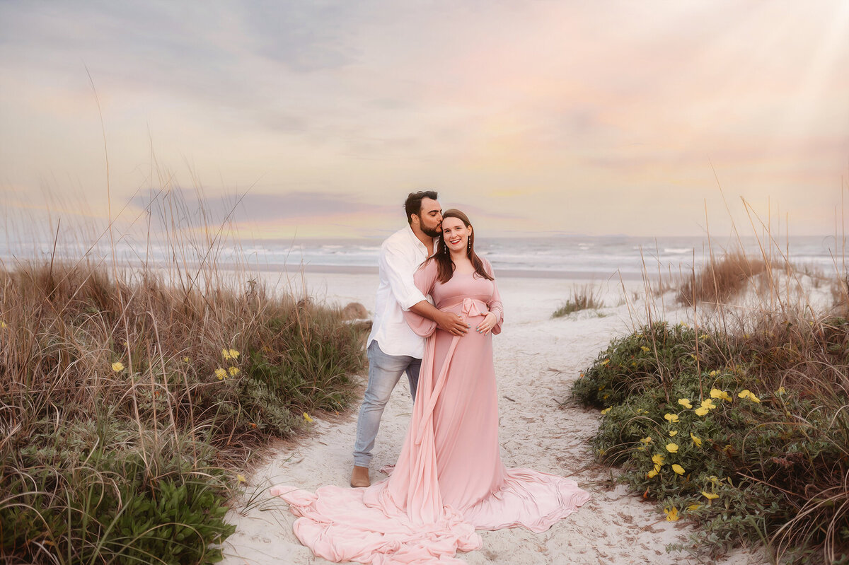 During their Babymoon in Charleston, expectant parents pose for Beach Maternity Photos in Charleston, SC.