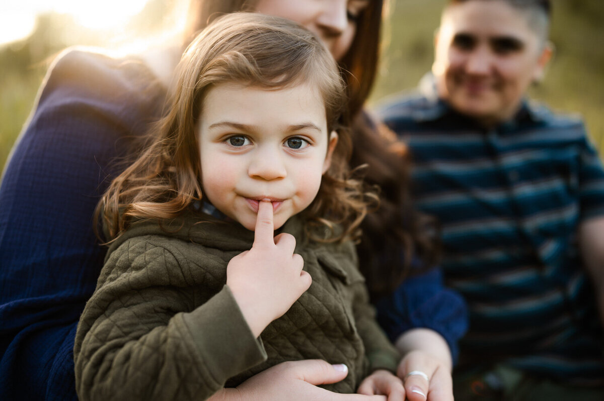 child looking at camera with finger in his mouth