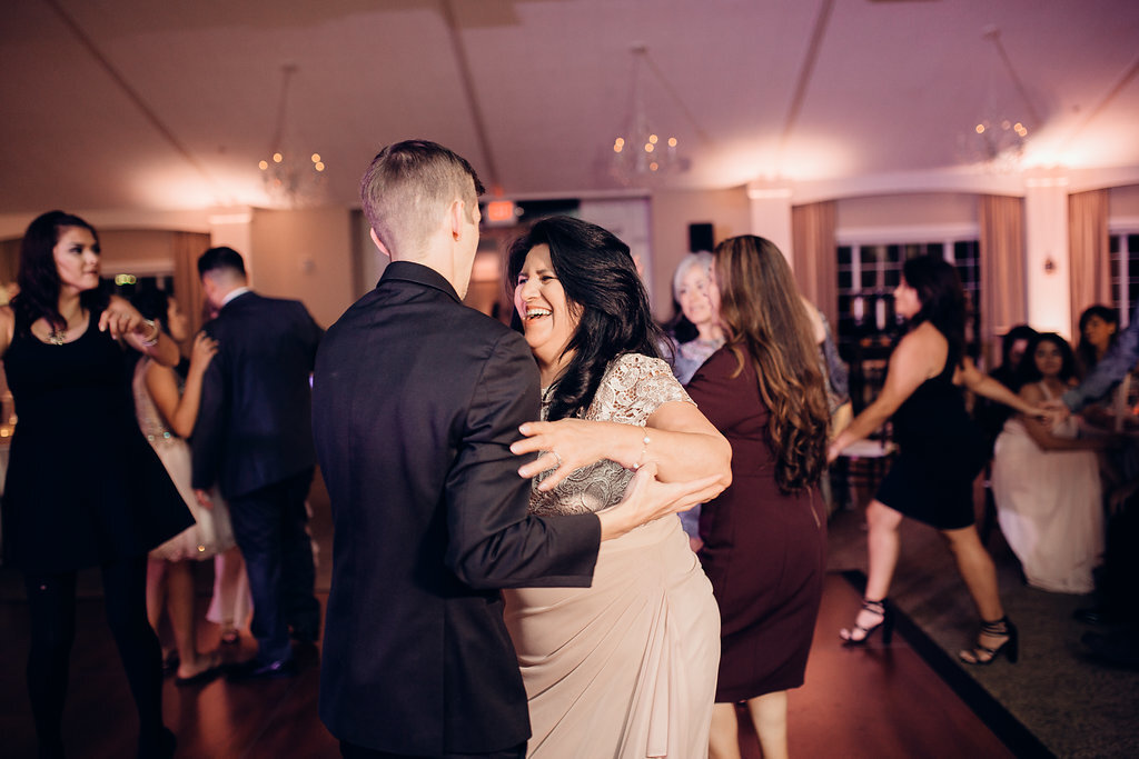 Wedding Photograph Of Woman Laughing While Talking To The Groom Los Angeles