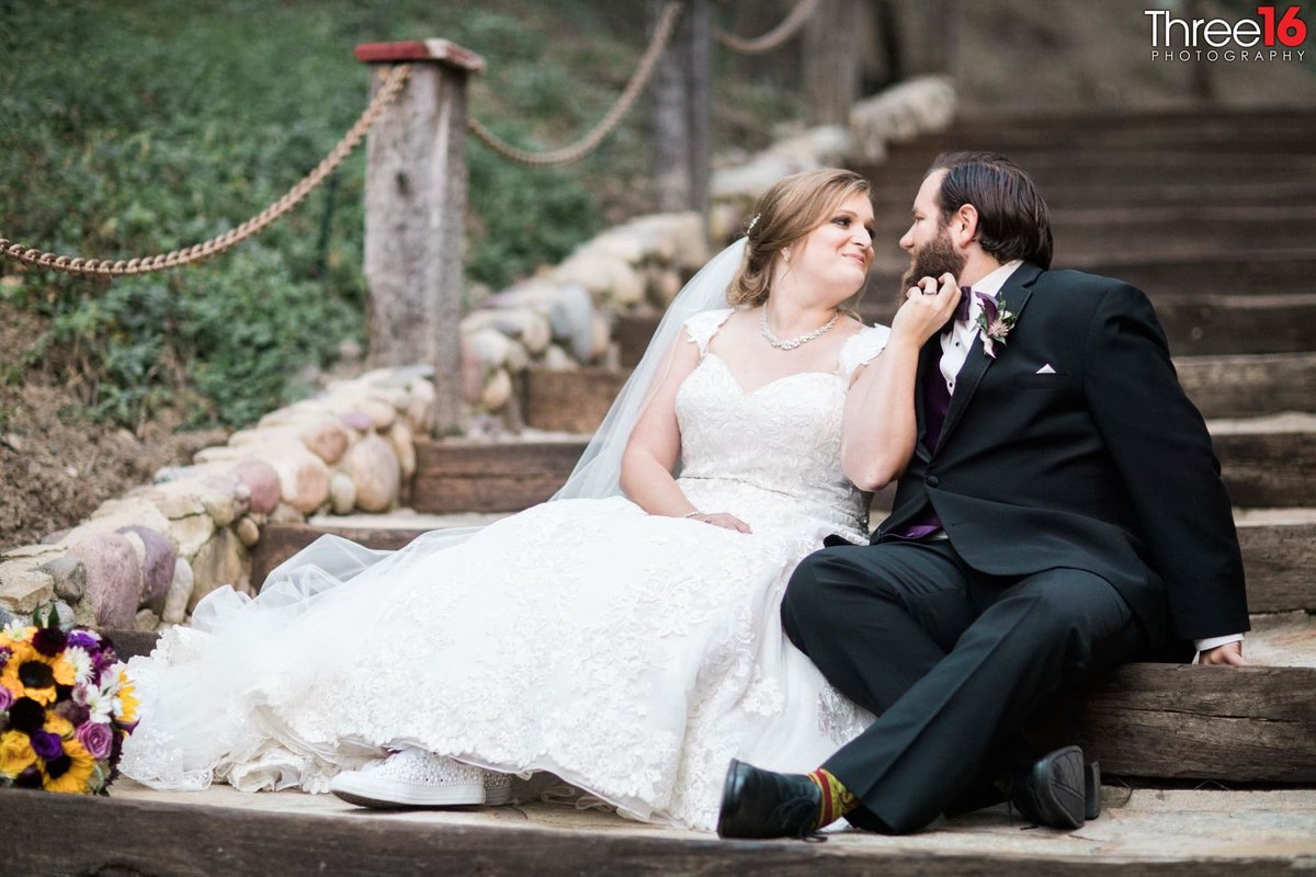 Bride and Groom share a quiet moment sitting on the steps