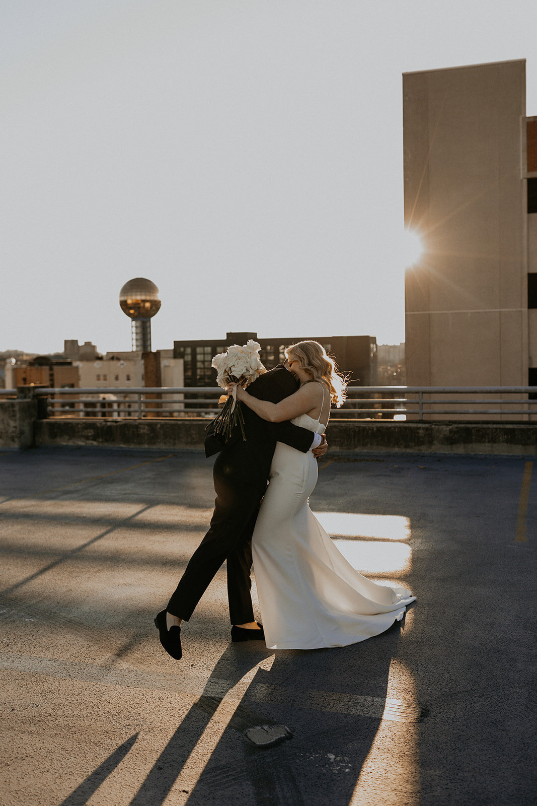 bride and groom in downtown Knoxville with the Sunsphere in the back